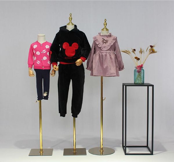 Children's commercial furniture props featuring half-length boys' and girls' wear on gold-based shop window display dummies with small stage frames