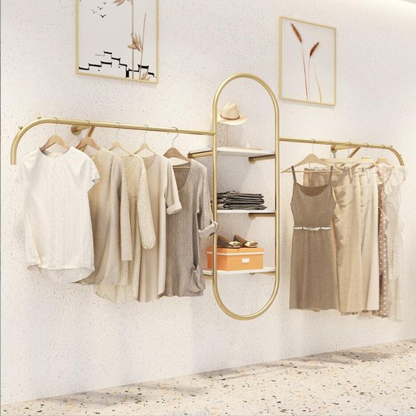 Commercial furniture display racks for women's clothing shops, featuring wall-mounted golden shelves