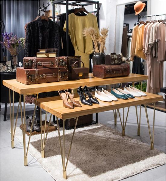 Commercial furniture with rectangular iron floor frames and marble-topped solid wood tables in simple mid to low-height designs