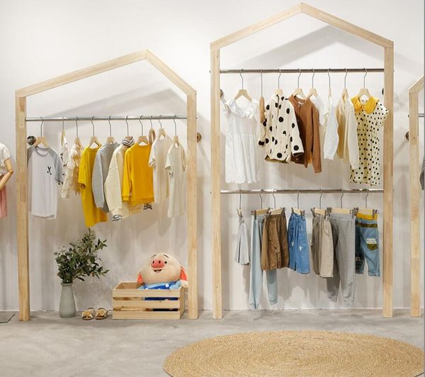 Creative roof display racks for children's clothing stores, combining stainless steel and solid wood wall-mounted hanging furniture