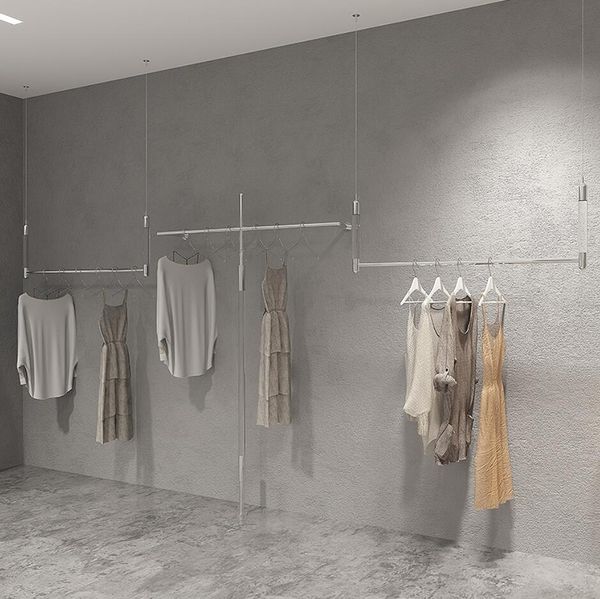 Display wall-mounted clothing racks in stores with commercial acrylic and stainless steel hanging shelves for women's apparel