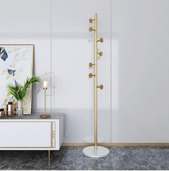 Elegant golden coat rack for bedrooms, featuring Nordic marble and metal hooks, a minimalist modern luxury home accessory