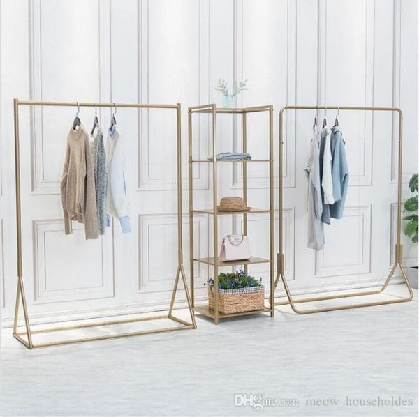Golden clothing rack for bedroom or store display, showcasing men's and women's garments