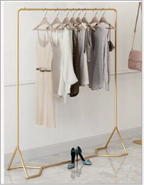 Golden clothing store display shelf for commercial use, featuring ground-mounted gold dress hangers for women's apparel shops