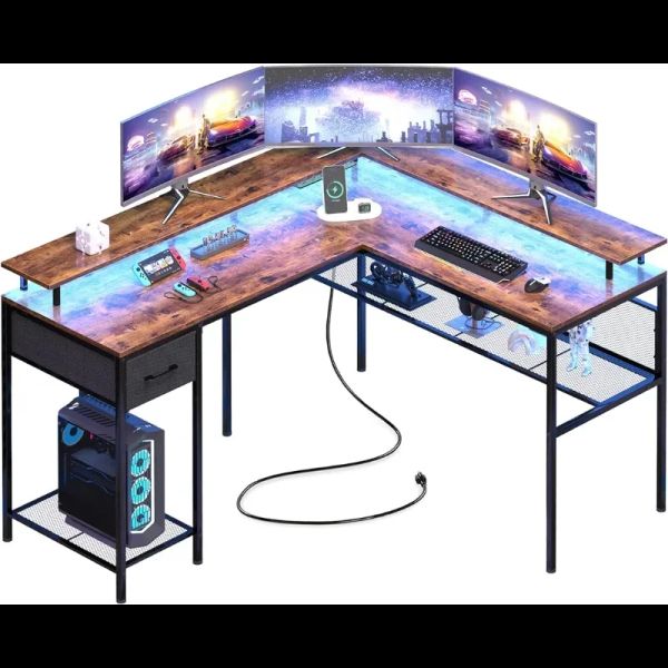 L-shaped gaming desk with LED lights, power outlets, and storage shelves
