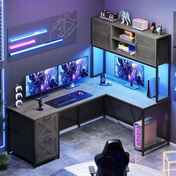 L-shaped gaming desk with reversible design, fabric drawers, built-in power outlet, LED lighting, hutch, and storage shelf
