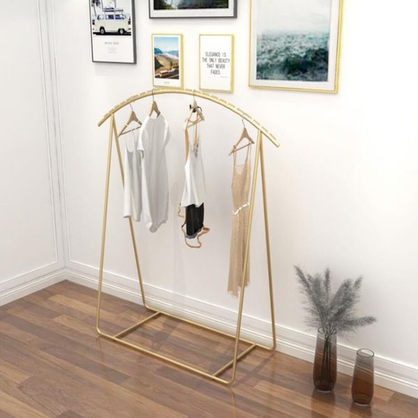 Men's and women's clothing display stands for retail stores, featuring floor-mounted gold shoe racks