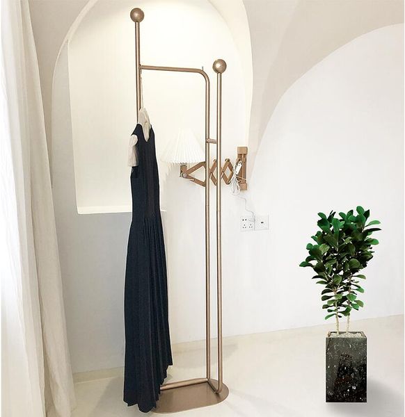 Nordic-inspired metal coat hanger rack for modern bedrooms, a sleek and simple clothes shelf
