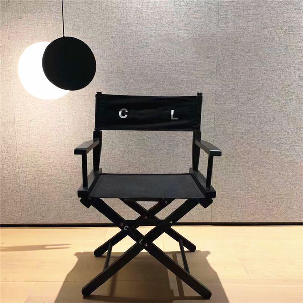 Red and black folding director's chair made of solid wood, ideal for camping, fishing, and outdoor use