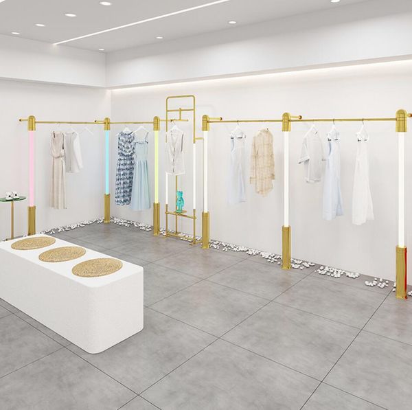 Women's clothing display rack with gold LED lighting, acrylic wall panels, and combination stands for retail store showcases